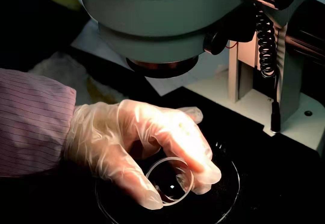 Coating optical lenses